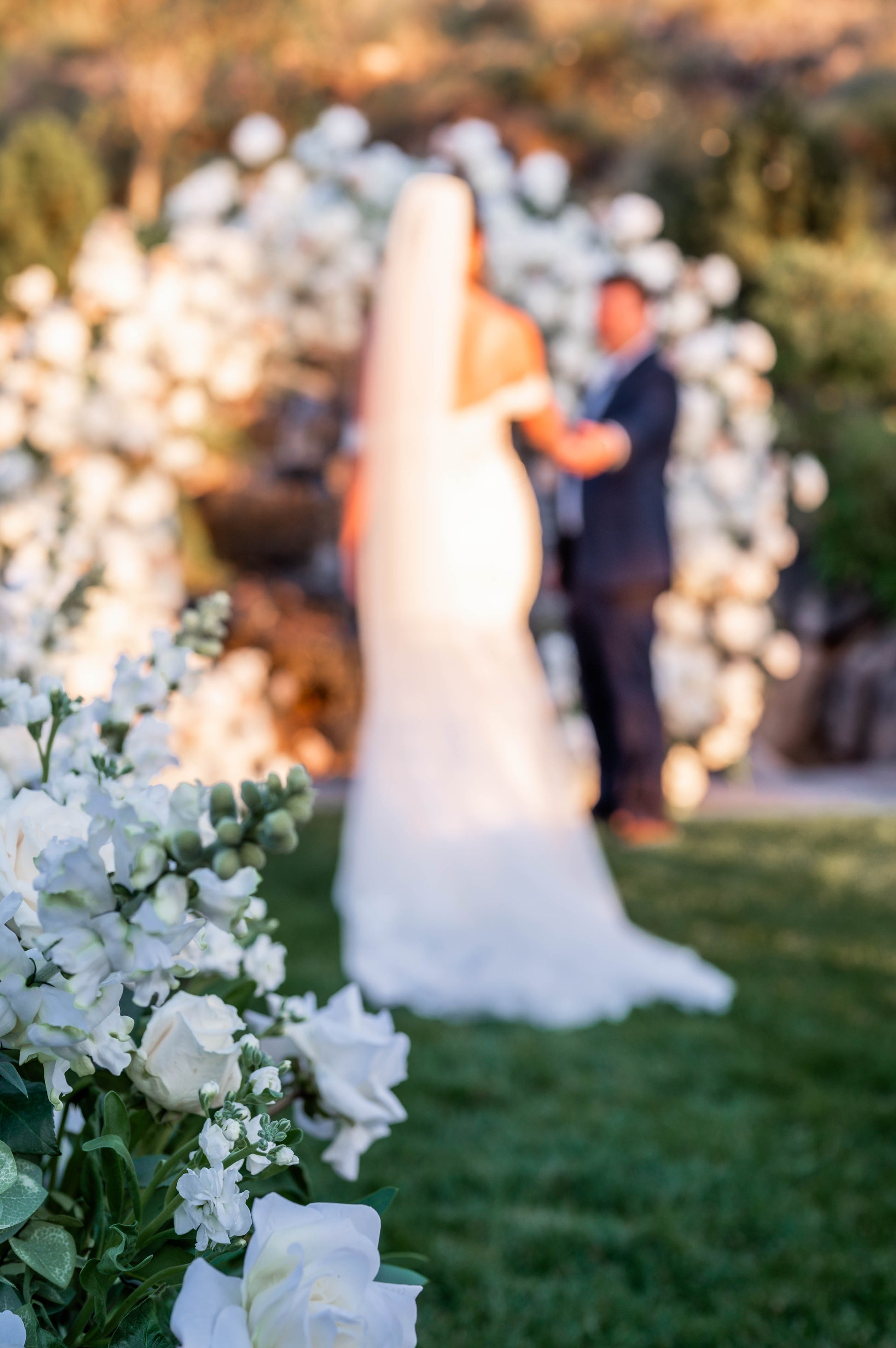 Wedding ceremony with white circle arch covered in flowers